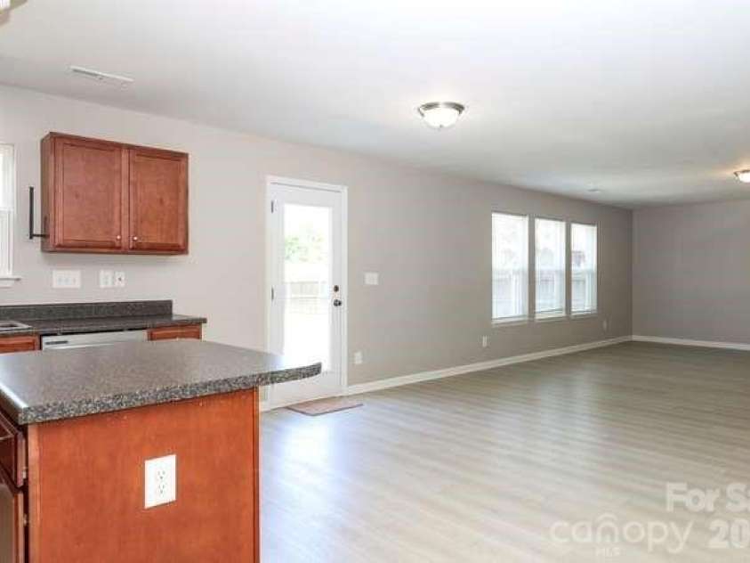 1212 Catawba Run, Lowell, NC 28098.  MLS# CAR4376003, YatesRealty ID 17996. Kitchen island and great room.