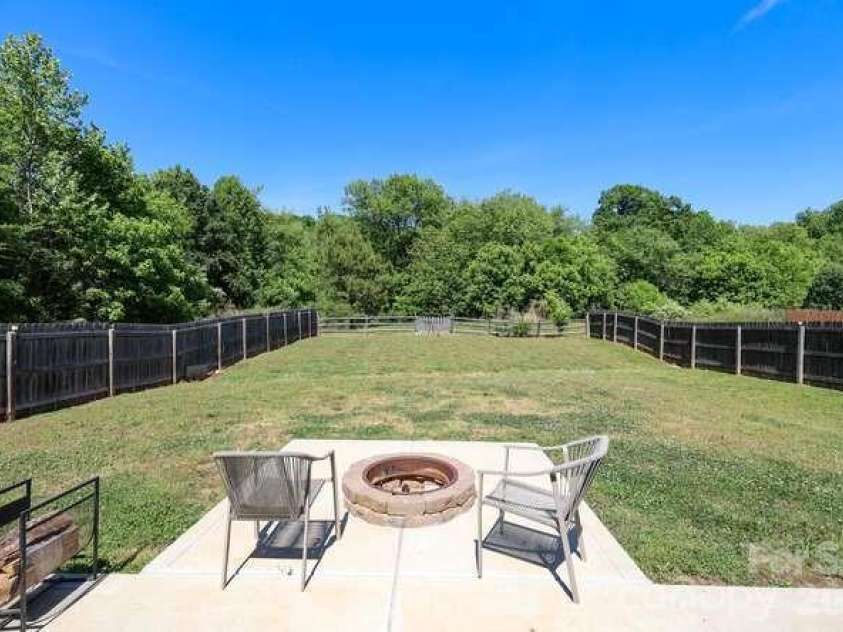 1212 Catawba Run, Lowell, NC 28098.  MLS# CAR4376003, YatesRealty ID 17996. Large backyard, flat with built in fire pit