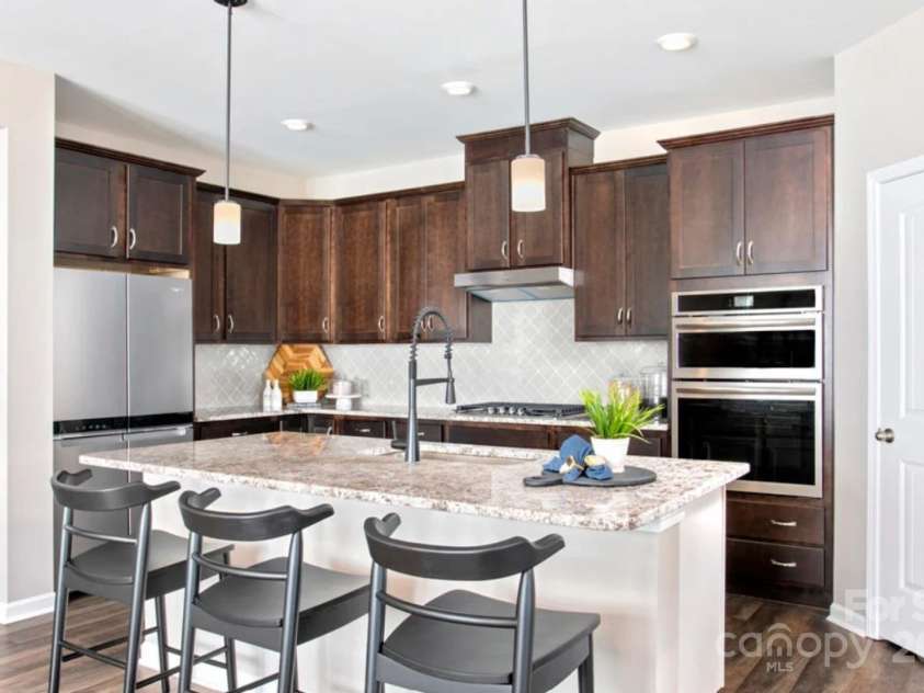 5276 Scotts Creek Road, Indian Land, SC 29707.  MLS# CAR4187687, YatesRealty ID 18. This is not actual kitchen, just a representation for size and layout.  The actual kitchen will have white cabinets, a gas range and microwave above the range.  Where you see the microwave and wall oven, there will b