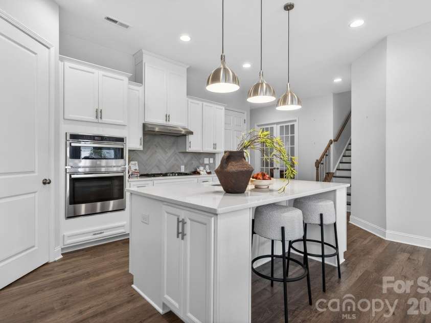 18018 Grey Mossrun Drive, Charlotte, NC 28278.  MLS# CAR4366883, YatesRealty ID 18005. Modern pendant lighting illuminates counter seating