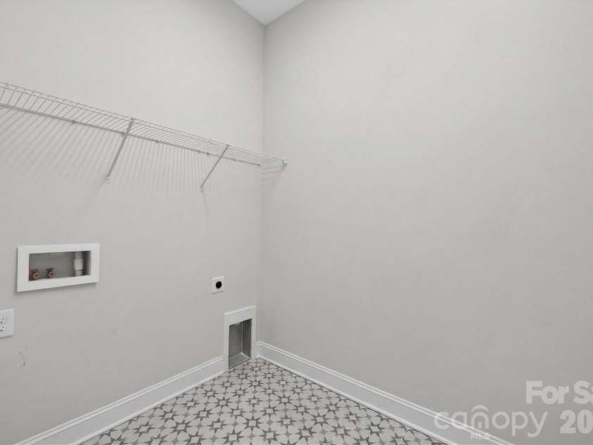 18018 Grey Mossrun Drive, Charlotte, NC 28278.  MLS# CAR4366883, YatesRealty ID 18005. The large laundry room has modern floor tile