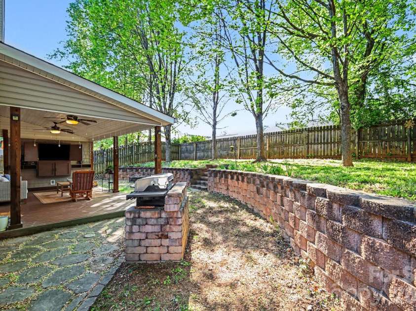 230 Lylic Woods Drive, Fort Mill, SC 29715.  MLS# CAR4375765, YatesRealty ID 18011. Beautiful Backyard space with covered patio