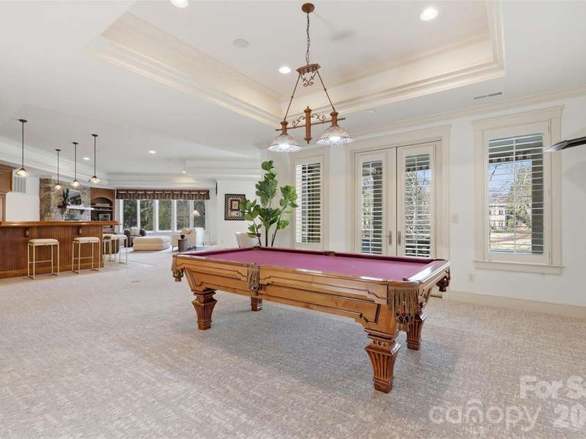 14606 Jockeys Ridge Drive, Charlotte, NC 28277.  MLS# CAR4356748, YatesRealty ID 18019. The basement opens up. Billiard table, full ceiling height, bar steps away. This is a second home beneath the first.