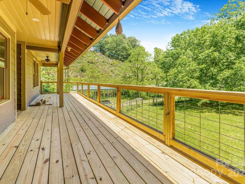 276 Morgan Branch Road, Marshall, NC 28753.  MLS# CAR4264012, YatesRealty ID 18026. Covered deck looking over horse paddock.
