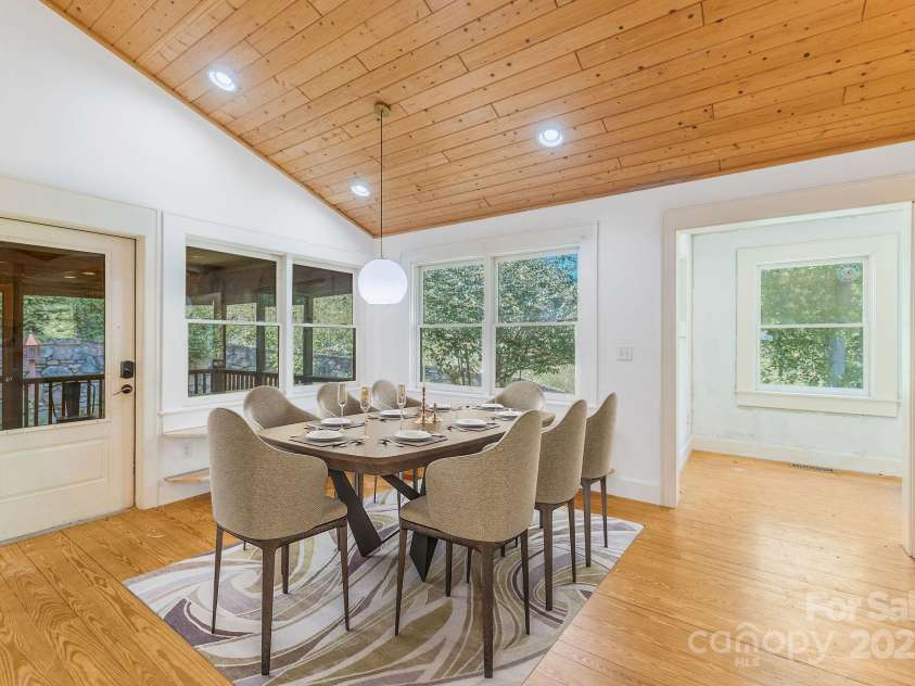 276 Morgan Branch Road, Marshall, NC 28753.  MLS# CAR4264012, YatesRealty ID 18026. Dining room next to kitchen, door leads to screened porch. Virtually staged.