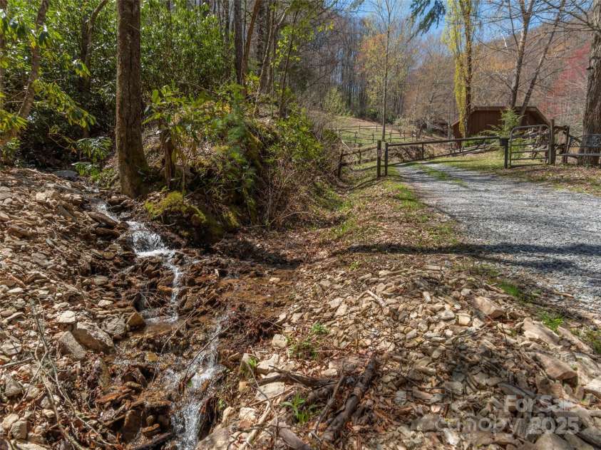 90 Junco Trail, Waynesville, NC 28785.  MLS# CAR4252158, YatesRealty ID 18032. 3rd mini waterfall/stream that greets you at the gate upon entering the property