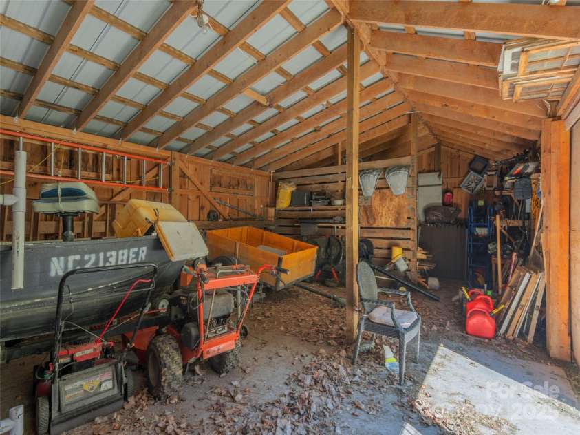 90 Junco Trail, Waynesville, NC 28785.  MLS# CAR4252158, YatesRealty ID 18032. Barn Interior also includes a workbench or tack room area
