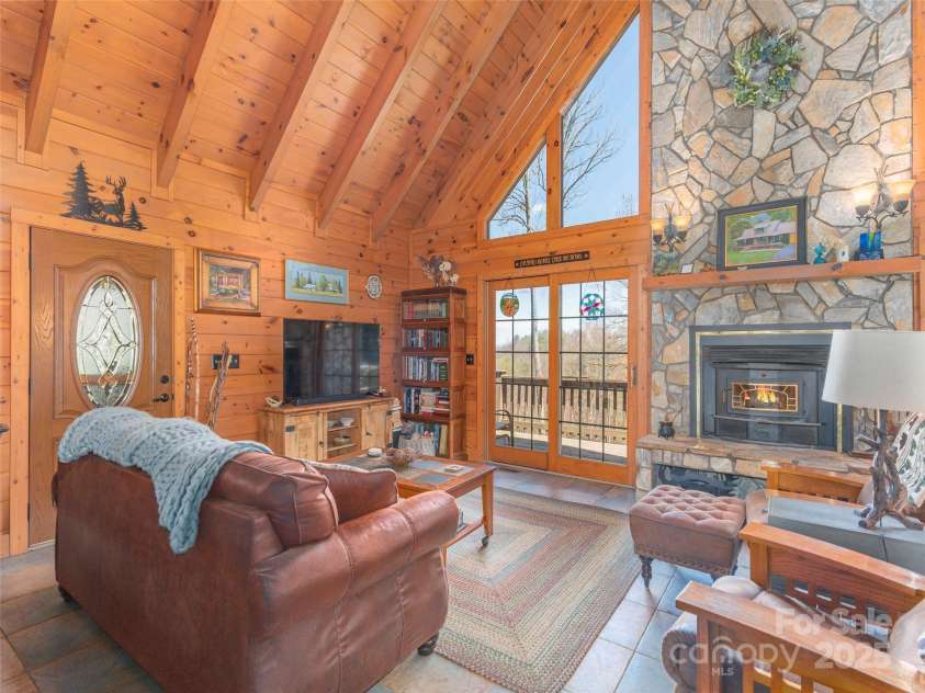 90 Junco Trail, Waynesville, NC 28785.  MLS# CAR4252158, YatesRealty ID 18032. Great Room - Living Area with Stone Wood-Burning Fireplace Feature