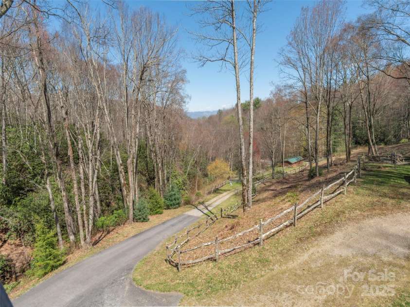 90 Junco Trail, Waynesville, NC 28785.  MLS# CAR4252158, YatesRealty ID 18032. Porch View of Driveway from Property Gate and Barn area.