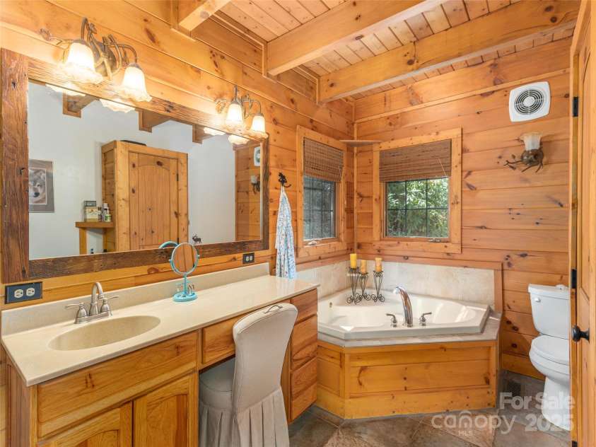 90 Junco Trail, Waynesville, NC 28785.  MLS# CAR4252158, YatesRealty ID 18032. Primary Suite Full Bath with generously sized Jetted tub, custom tiled shower, linen closet and vanity