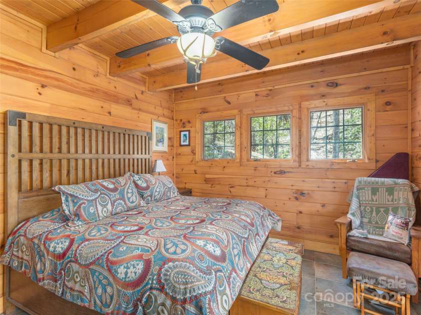 90 Junco Trail, Waynesville, NC 28785.  MLS# CAR4252158, YatesRealty ID 18032. Primary Suite on the Main Level with extra large walk-in closet with custom built-ins
