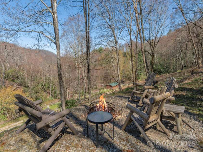 90 Junco Trail, Waynesville, NC 28785.  MLS# CAR4252158, YatesRealty ID 18032. Relaxing Firepit area soaking up the paneramic wooded view
