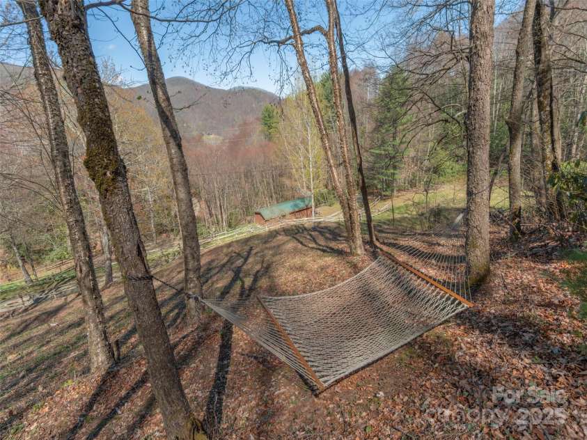 90 Junco Trail, Waynesville, NC 28785.  MLS# CAR4252158, YatesRealty ID 18032. Soak up the afternoon view relaxing in the hammock just beside the outdoor firepit area
