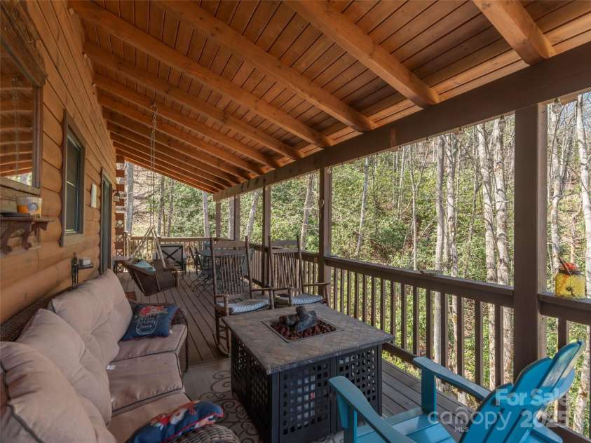 90 Junco Trail, Waynesville, NC 28785.  MLS# CAR4252158, YatesRealty ID 18032. Upper Level Wrap Around Porch/Deck Area facing the rushing stream
