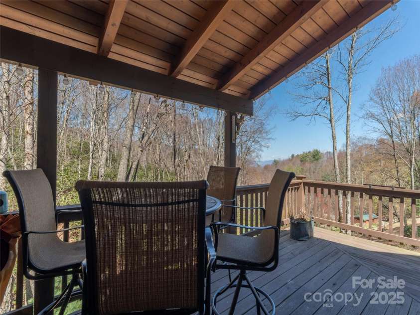 90 Junco Trail, Waynesville, NC 28785.  MLS# CAR4252158, YatesRealty ID 18032. Upper Level Wrap Around Porch/Deck Area facing the rushing stream with dedicated dining and grill areas