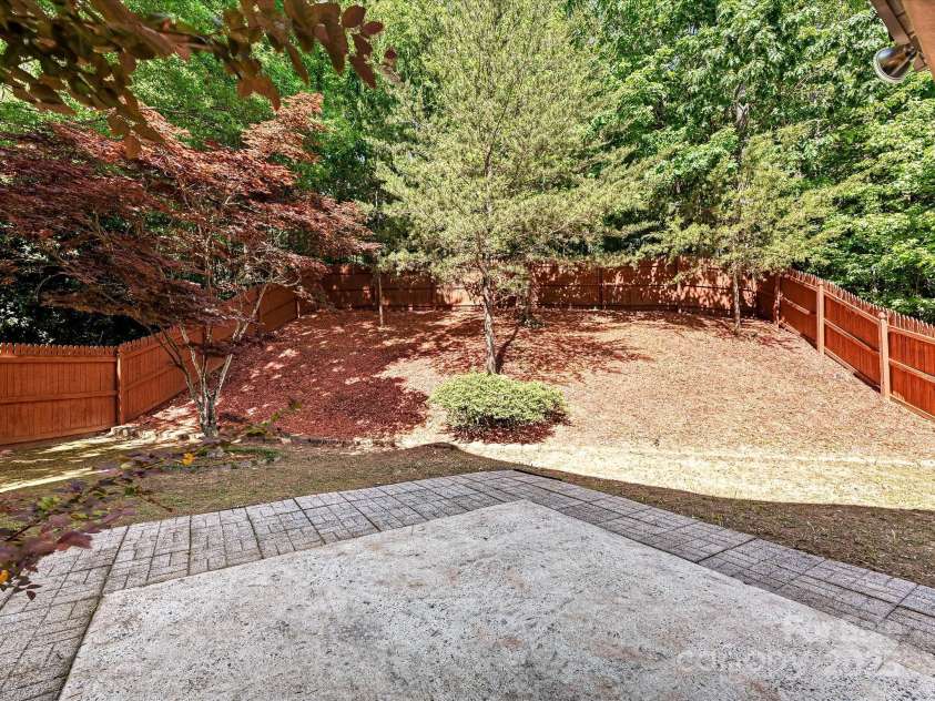 7923 Shiny Meadow Lane, Charlotte, NC 28215.  MLS# CAR4252293, YatesRealty ID 18034. An expanded patio and beautiful trees are featured
