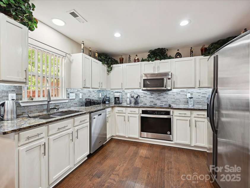 7923 Shiny Meadow Lane, Charlotte, NC 28215.  MLS# CAR4252293, YatesRealty ID 18034. Painted Cabinetry and Stainless Steel Appliances are featured