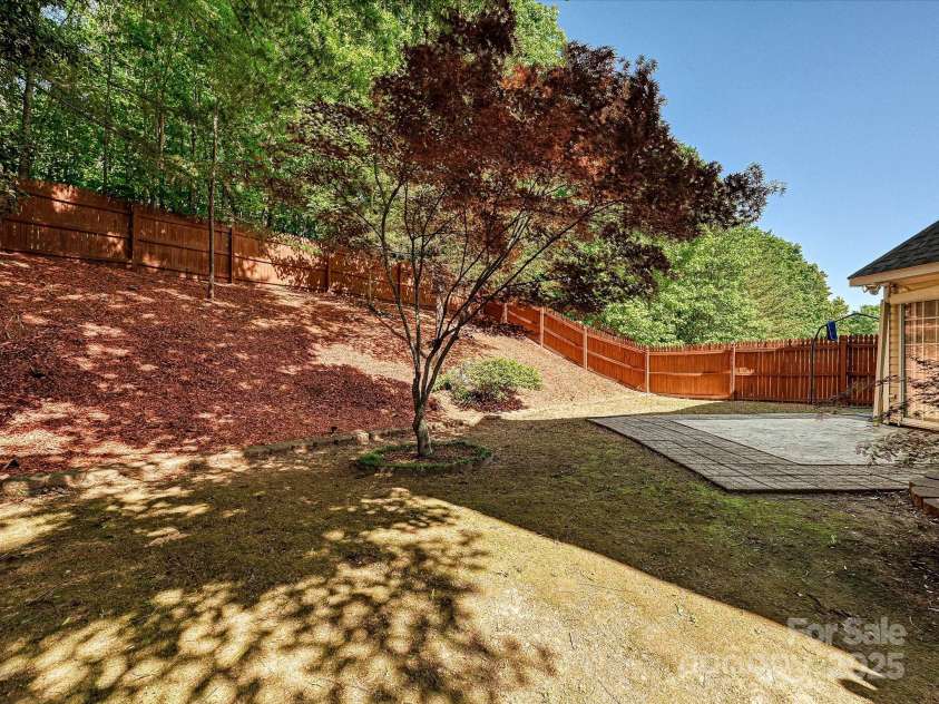 7923 Shiny Meadow Lane, Charlotte, NC 28215.  MLS# CAR4252293, YatesRealty ID 18034. Wooded surround and fencing lends privacy.