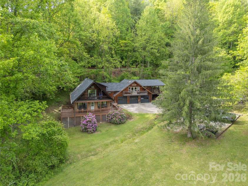 919 Country Club Drive, Cullowhee, NC 28723.  MLS# CAR4374654, YatesRealty ID 18038. Property line runs along the creek and includes the lot to the left and right of the house.