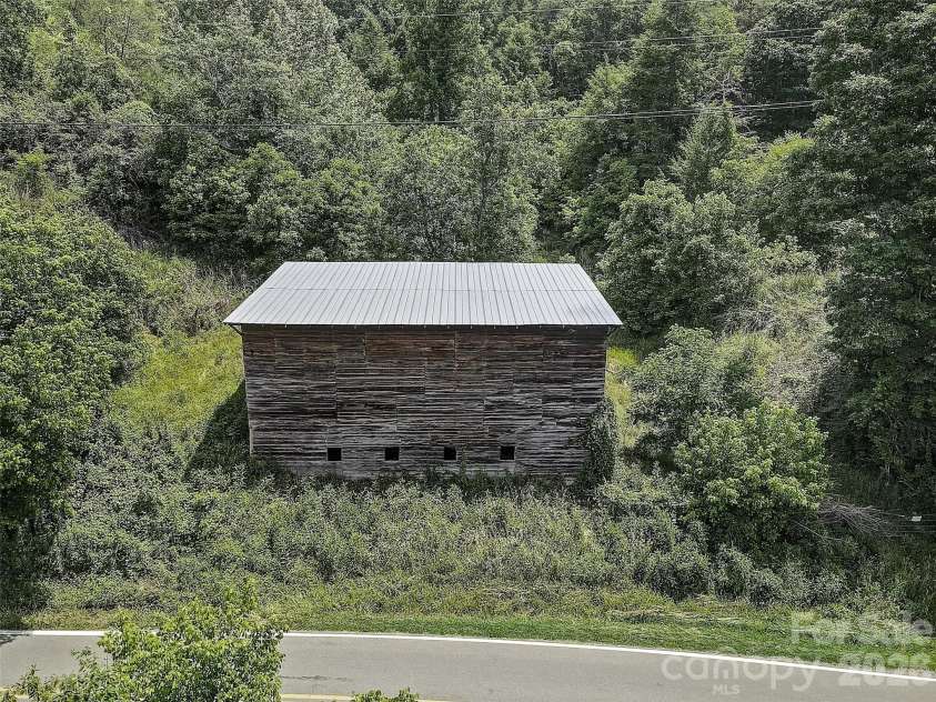 1820 Grapevine Road, Marshall, NC 28753.  MLS# CAR4359708, YatesRealty ID 18045. Old Tobacco Barn