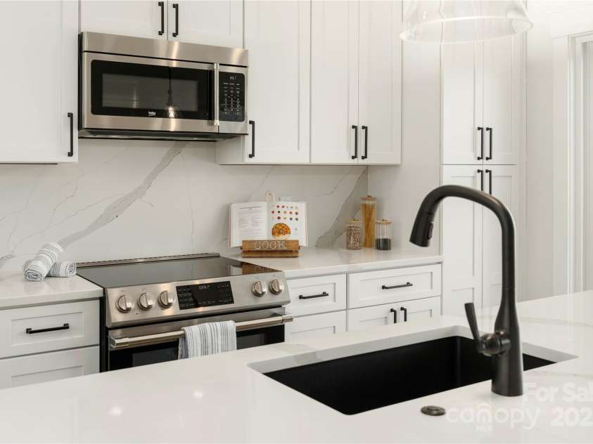 108 Isle Of Pines Road, Mooresville, NC 28117.  MLS# CAR4307197, YatesRealty ID 1805. Sleek and efficient kitchen with quartz countertops and backsplash - interior of lot 1 home