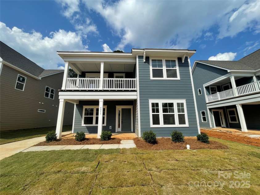 4033 Grommet Court, Matthews, NC 28105.  MLS# CAR4254660, YatesRealty ID 18061. Front Exterior. 2 car detached, oversized garage with a finished studio above. Studio includes separate hot water heaters, AC/heat, 1/2 bath and WIC