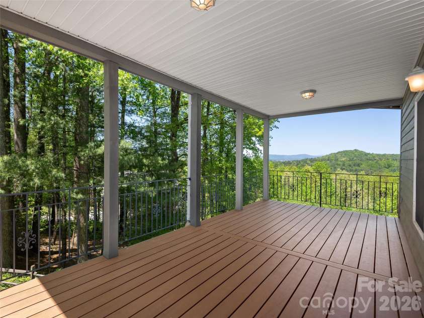 126 Stonebridge Drive, Hendersonville, NC 28739.  MLS# CAR4374699, YatesRealty ID 18072. Downstairs Deck with a Mountain View