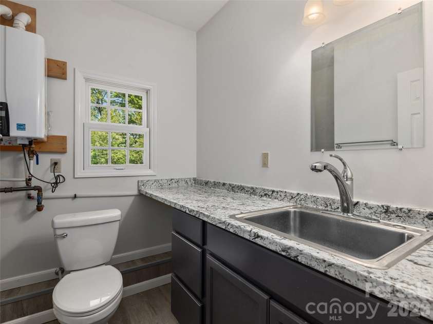 126 Stonebridge Drive, Hendersonville, NC 28739.  MLS# CAR4374699, YatesRealty ID 18072. Half Bath off Workshop