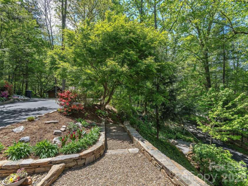 126 Stonebridge Drive, Hendersonville, NC 28739.  MLS# CAR4374699, YatesRealty ID 18072. Pathway to Back Yard and Fire Pit