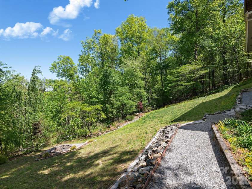 126 Stonebridge Drive, Hendersonville, NC 28739.  MLS# CAR4374699, YatesRealty ID 18072. Pathway to Back Yard and Fire Pit