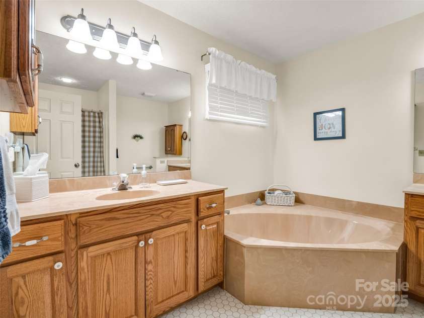 11 Wedge Court, Hendersonville, NC 28739.  MLS# CAR4260142, YatesRealty ID 18075. Primary bath with soaking tub and step in shower