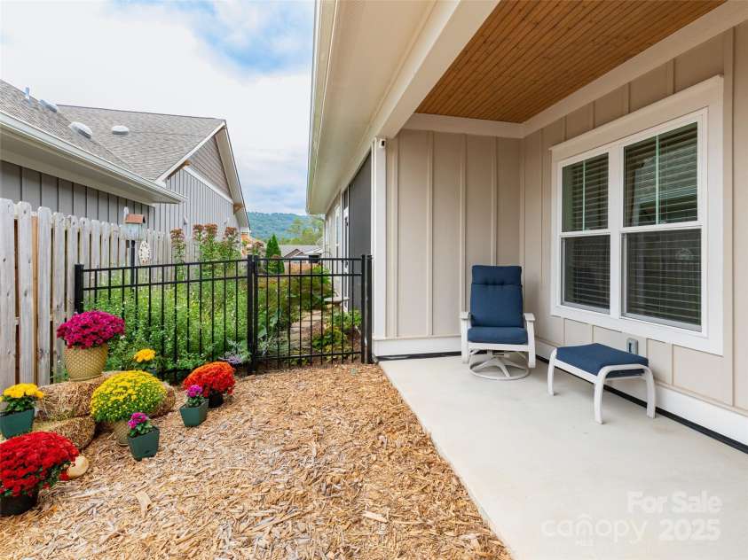 32 Cozy Cottage Way, Arden, NC 28704.  MLS# CAR4308259, YatesRealty ID 18080. Stay out of the rain on the covered porch while your pets explore the safety of fenced in back yard space.