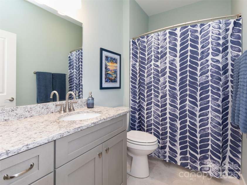 32 Cozy Cottage Way, Arden, NC 28704.  MLS# CAR4308259, YatesRealty ID 18080. The common bathroom awaits those in need.