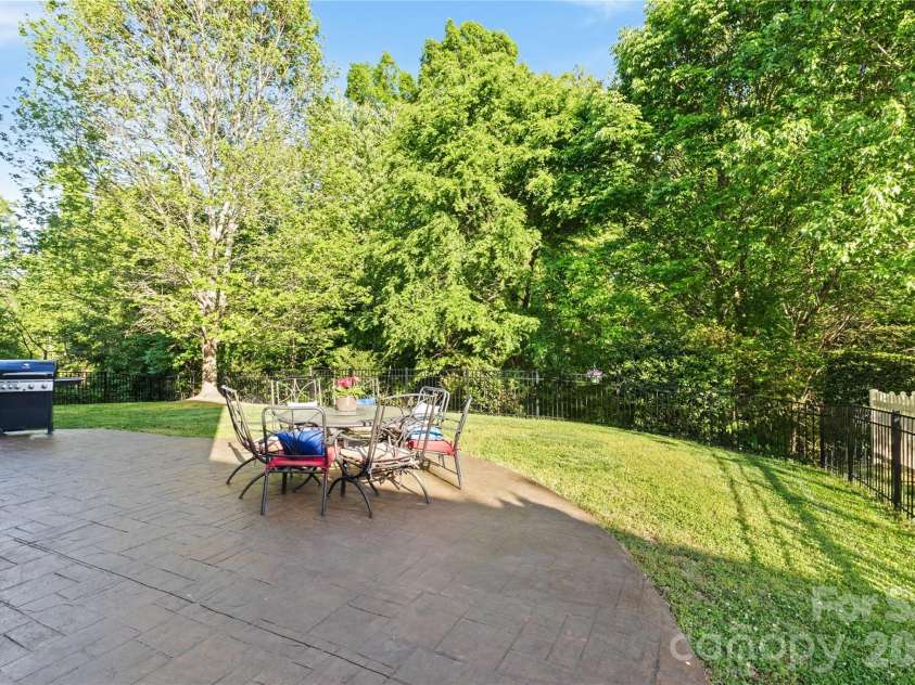 8458 Mossy Cup Trail, Harrisburg, NC 28075.  MLS# CAR4372770, YatesRealty ID 18086. Custom Oversized Patio in rear yard that has prvacy with trees,