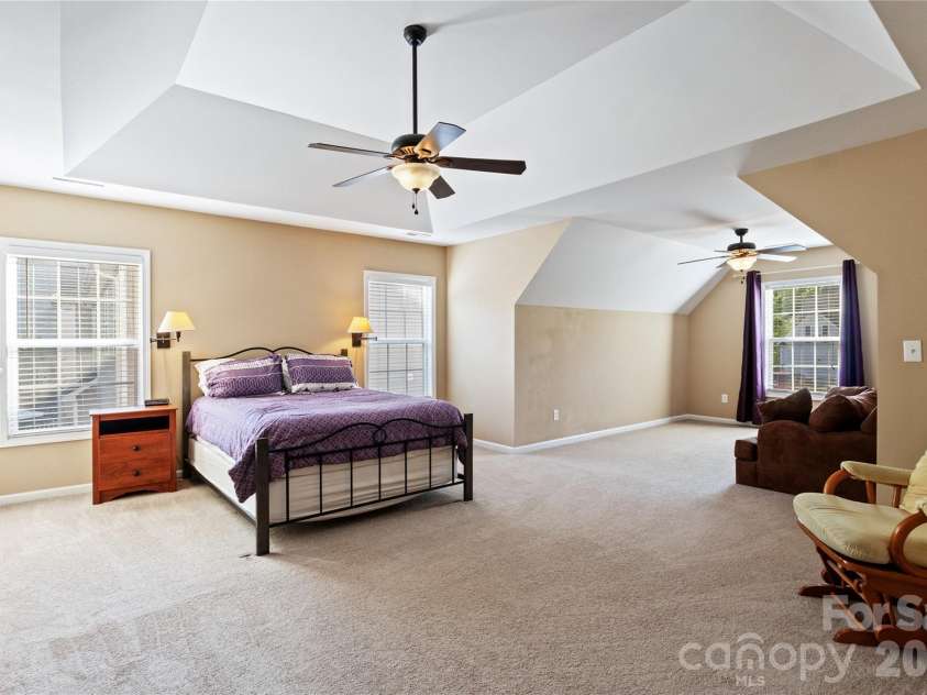 8458 Mossy Cup Trail, Harrisburg, NC 28075.  MLS# CAR4372770, YatesRealty ID 18086. Huge Primary Bedroom with Trey Ceiling that opens to Separat Sitting Area with Clipped Ceiling.