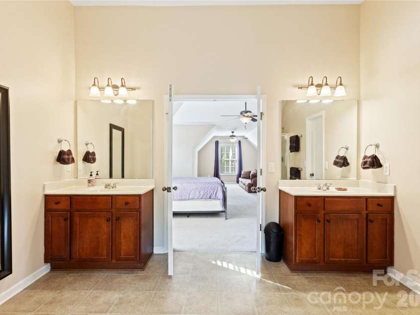 8458 Mossy Cup Trail, Harrisburg, NC 28075.  MLS# CAR4372770, YatesRealty ID 18086. Primary Bathroom with Double Vanities.