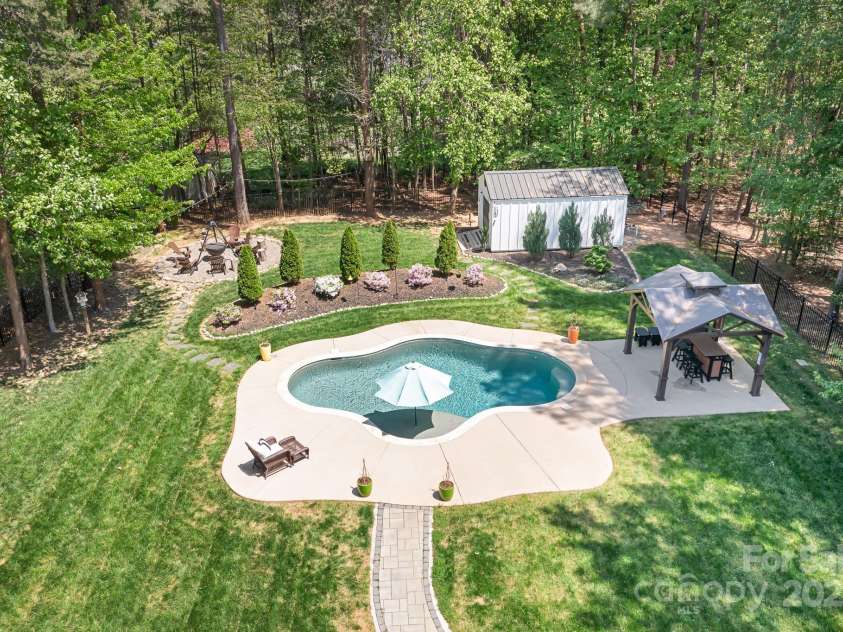 317 Marietta Road, Mooresville, NC 28117.  MLS# CAR4253368, YatesRealty ID 18093. Back yard Oasis complete with salt water free form pool that was recently resurfaced.