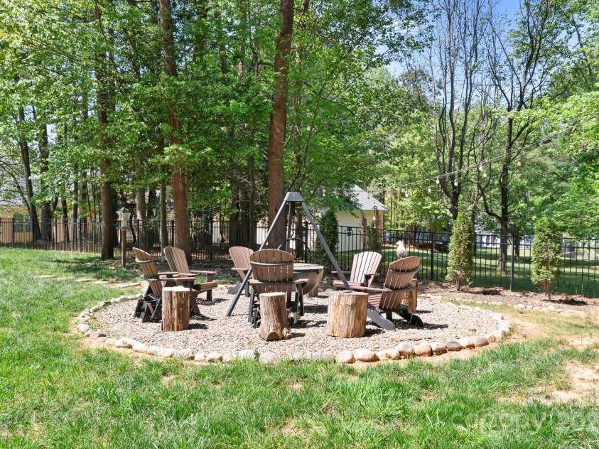 317 Marietta Road, Mooresville, NC 28117.  MLS# CAR4253368, YatesRealty ID 18093. Designed to be a fire pit, the black iron cauldron does not convey as it is not bolted or affixed but area is ready for your fire pit accoutrements