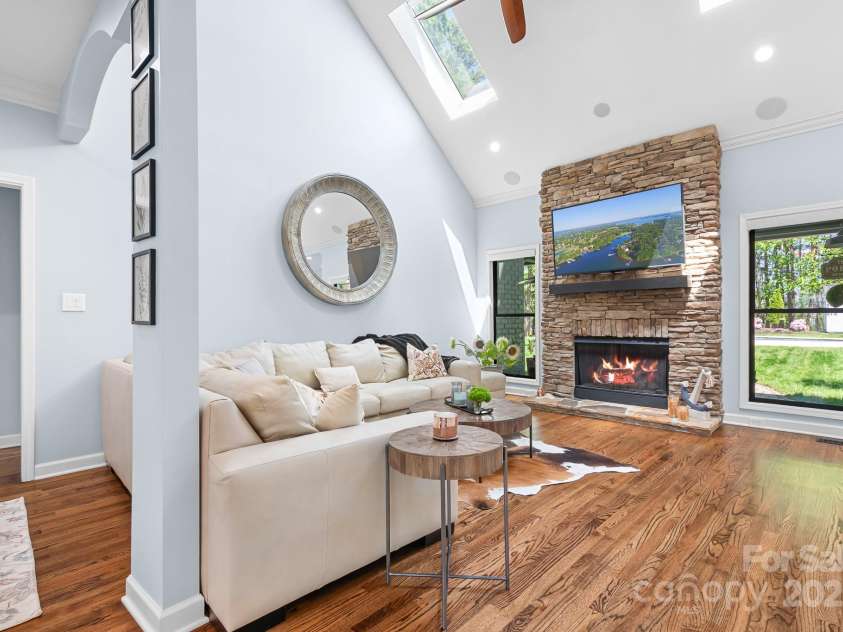 317 Marietta Road, Mooresville, NC 28117.  MLS# CAR4253368, YatesRealty ID 18093. Great Room anchored by stone fireplace  and featuring skylights and new windows.