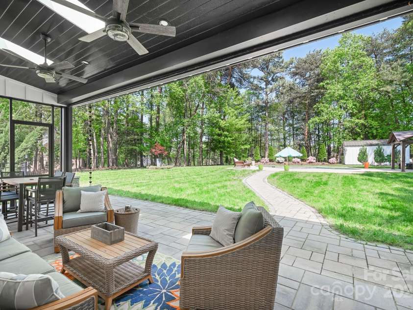 317 Marietta Road, Mooresville, NC 28117.  MLS# CAR4253368, YatesRealty ID 18093. New screened Patio with retractable screen.  Even when it's down it's so see through it looks like it's not there.  Love it!