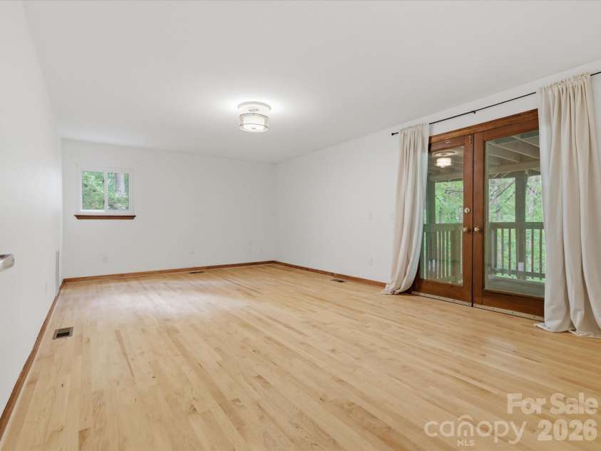 828 Old Bell Road, Charlotte, NC 28270.  MLS# CAR4374798, YatesRealty ID 18101. Bedroom / flex space on lower level with exit to the lower deck an wine cellar 