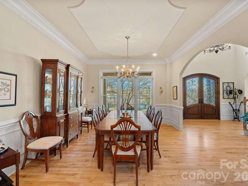 8056 Windsong Road, Denver, NC 28037.  MLS# CAR4338540, YatesRealty ID 18104. Elegant dining room with custom tray ceiling, crown molding, and wainscoting.