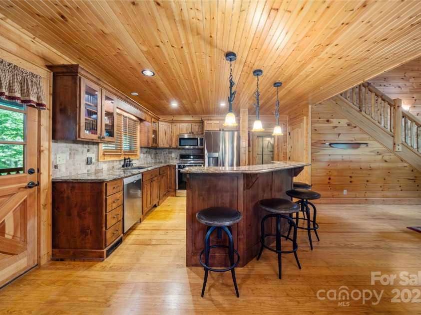 86 Sweet Birch Drive, Maggie Valley, NC 28751.  MLS# CAR4261566, YatesRealty ID 18106. Access to screened in porch with sounds of the bold creek