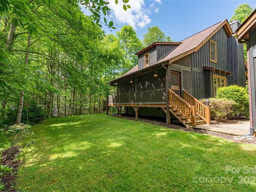 86 Sweet Birch Drive, Maggie Valley, NC 28751.  MLS# CAR4261566, YatesRealty ID 18106. Back Yard and screened porch
