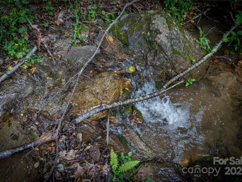 86 Sweet Birch Drive, Maggie Valley, NC 28751.  MLS# CAR4261566, YatesRealty ID 18106. Creek