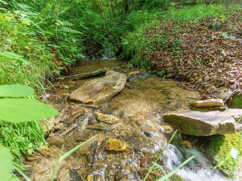 86 Sweet Birch Drive, Maggie Valley, NC 28751.  MLS# CAR4261566, YatesRealty ID 18106. Creek in back