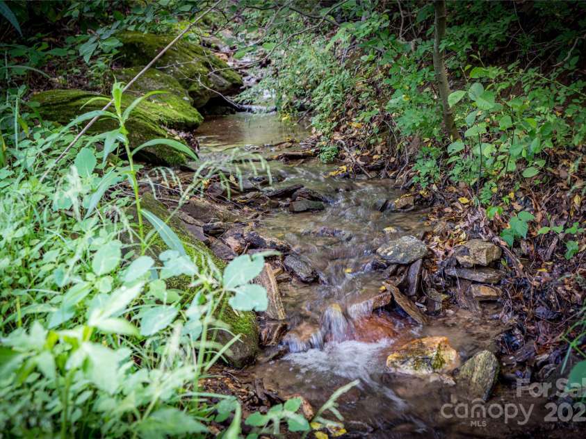 86 Sweet Birch Drive, Maggie Valley, NC 28751.  MLS# CAR4261566, YatesRealty ID 18106. Creek in back yard