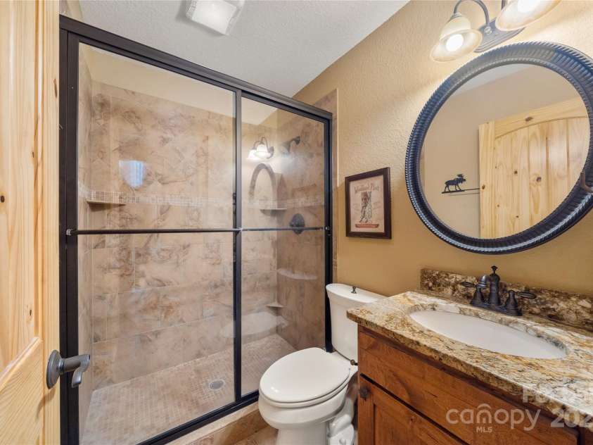 86 Sweet Birch Drive, Maggie Valley, NC 28751.  MLS# CAR4261566, YatesRealty ID 18106. Granite & Tile in bath on main level in the bedroom wing