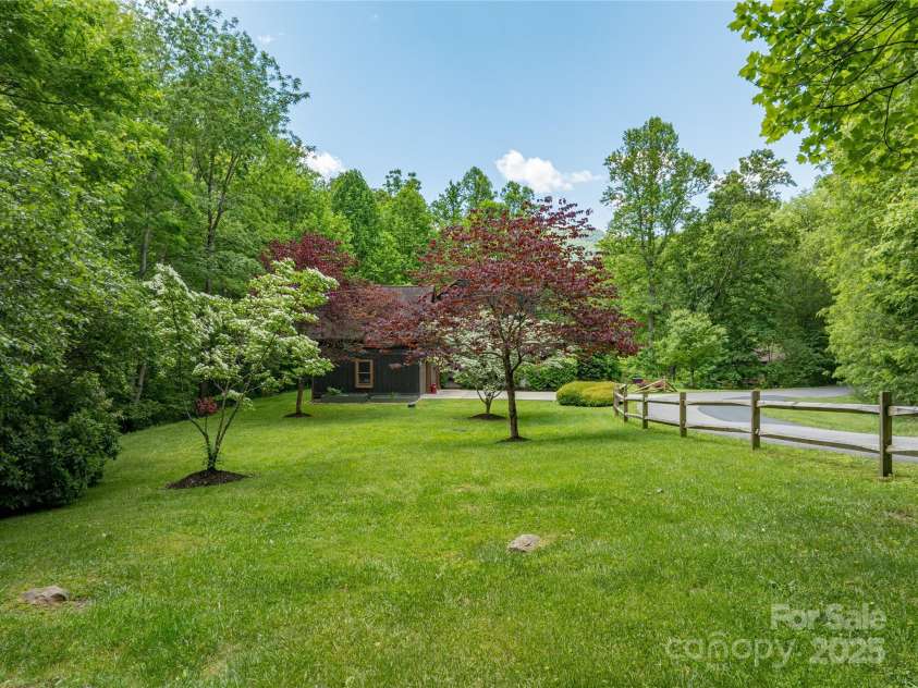 86 Sweet Birch Drive, Maggie Valley, NC 28751.  MLS# CAR4261566, YatesRealty ID 18106. Park like side yard