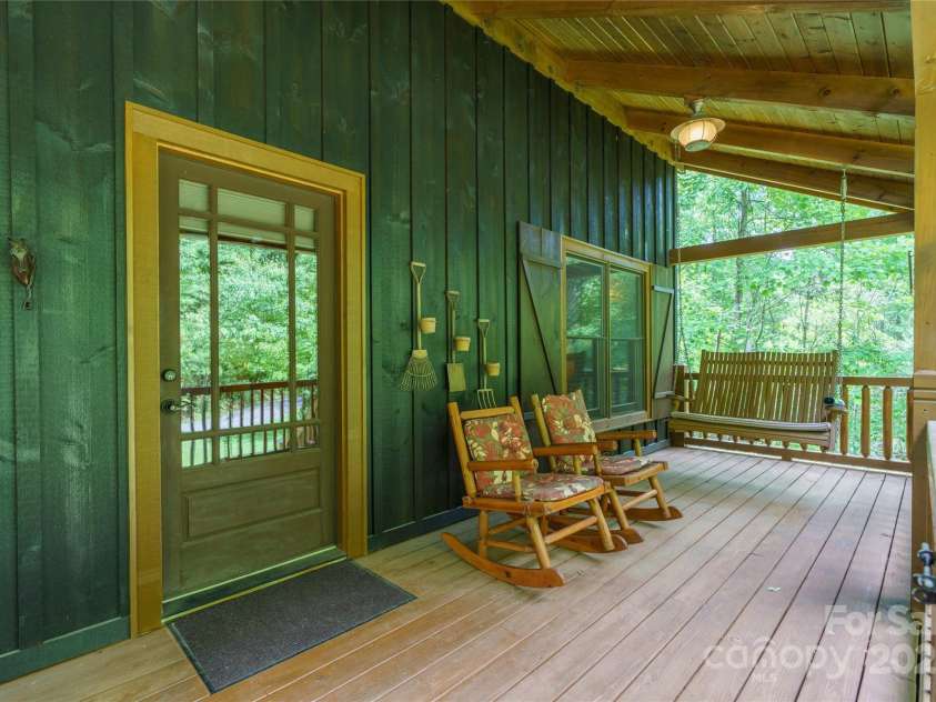 86 Sweet Birch Drive, Maggie Valley, NC 28751.  MLS# CAR4261566, YatesRealty ID 18106. Swing on front porch